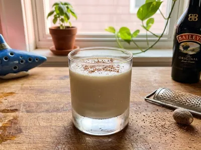 My Hero's Rest — creamy Lon Lon Milk with freshly grated nutmeg, the blue ocarina at the edge of the frame