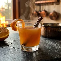 My Liquid Courage — warm amber drink with cinnamon and orange peel, Solaire's figurine at the edge