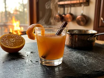 My Liquid Courage — warm amber drink with cinnamon and orange peel, Solaire's figurine at the edge